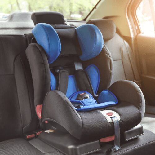A black and blue child car seat installed in a vehicle's back seat.