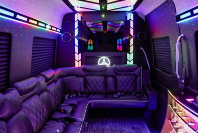Luxurious lounge area inside a vehicle with vibrant LED lighting.