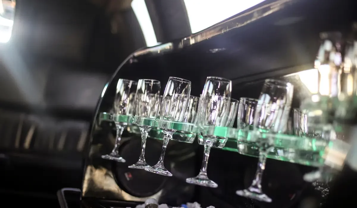 Champagne glasses inside a private limo where friends celebrate Halloween in style with comfort, elegance, and festive rides in Chicago.